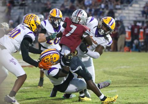Columbia defensive linemen Jaylen Underwood (right) and Terry Henry (bottom) stuff Madison County running back Davyon Gallon on Friday night at Boot Hill. (BRENT KUYKENDALL/Lake City Reporter)