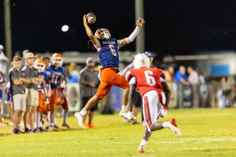 Branford running back TC Smith makes a leaping one-handed grab on fourth down against Hilliard on Friday. (JACK HOWDESHELL/Lake City Reporter)