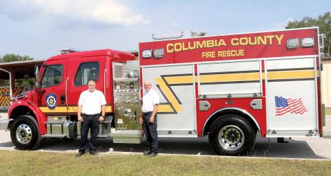 Columbia County Assistant Fire Chief Lance Hill (rom left) and Fire Chief Jeff Crawford look over the county’s newest fire truck that arrived Thursday. The truck, which was purchased for $480,393, is an Advanced Life Support unit, capable of pumping 1,250 gallons of water per minute and carries 1,000 gallons of water and can haul five firefighters. (TONY BRITT/Lake City Reporter)