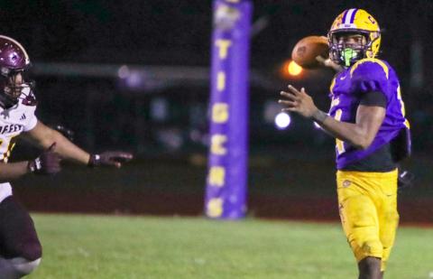 Columbia quarterback Xavier Collins rolls out to pass against Coffee last Friday. (BRENT KUYKENDALL/Lake City Reporter)