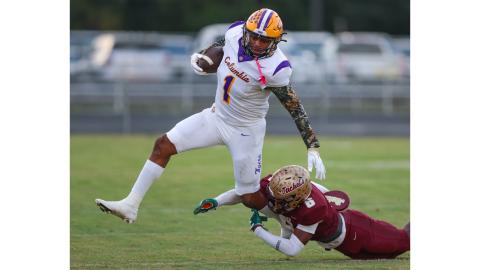 Columbia linebacker Kameron Mills gets tripped up by St. Augustine’s Marquell Elmore on a kickoff return Friday night. (GARY LLOYD MCCULLOUGH/Special to the Reporter)