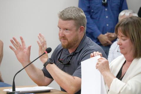 Stephen Douglas, a co-owner of Suwannee Iron Works, speaks during a public hearing Tuesday night in front of the Suwannee County Commission on the company’s request for a special exception to the county’s zoning and Land Development Regulations. Seated next to Douglas is Emily Pierce, one of the company’s attorneys. (JAMIE WACHTER/Lake City Reporter)