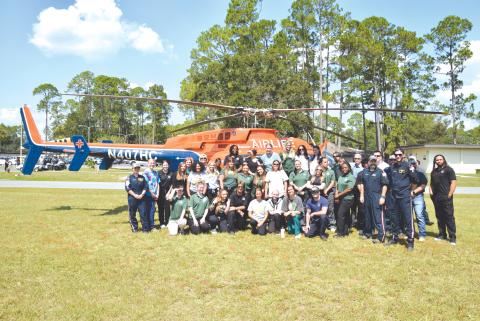 Florida Gateway College nursing students and AirLife crews pose in front of an AirLife emergency medical helicopter during last week’s demonstration. (COURTESY FLORIDA GATEWAY COLLEGE)