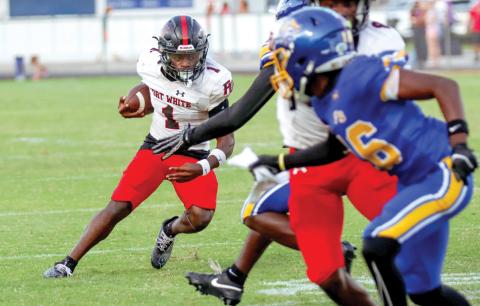 Fort White running back John’l Lawson looks for room to run Friday night against Fernandina Beach. (ASHLEY CHANDLER/Fernandina Beach News-Leader)