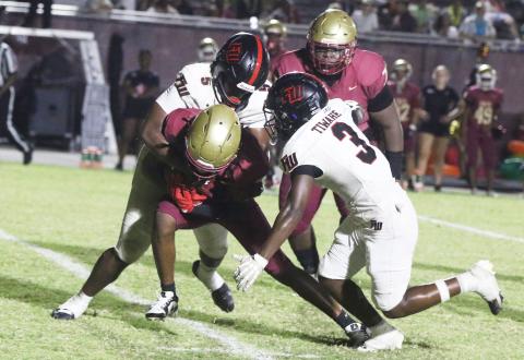 Fort White linebackers Darion Brinson (5) and Elijah Gardner (3) make a tackle against North Marion last Friday. (MORGAN MCMULLEN/Lake City Reporter)