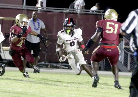 Fort White receiver Jayden Jackson looks for a lane on a sweep play Friday against North Marion. (MORGAN MCMULLEN/Lake City Reporter)