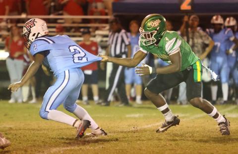 Suwannee linebacker Travis Fead grabs Wakulla running back Jeremiah Washington’s jersey as he tries to make a tackle on Friday. (PAUL BUCHANAN/Lake City Reporter)
