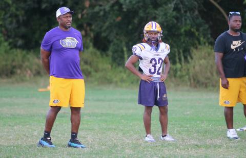 Drew Simmons (32) watches practice alongside Columbia coach Brian Allen (left) on Tuesday. (JORDAN KROEGER/Lake City Reporter)