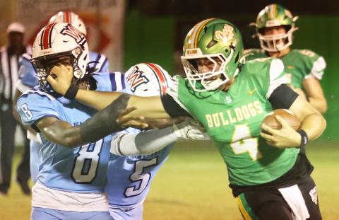 Suwannee quarterback Thomas Sikes stiff-arms Wakulla’s Rayshon St. Hilaire on a run Friday night. (PAUL BUCHANAN/Lake City Reporter)