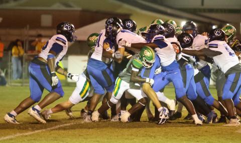 Godby quarterback Landon Dougherty reaches for the end zone as teammates push behind him Friday night at Langford Stadium. Suwannee’s Jayden Polite tries to hold him up. (PAUL BUCHANAN/Lake City Reporter)