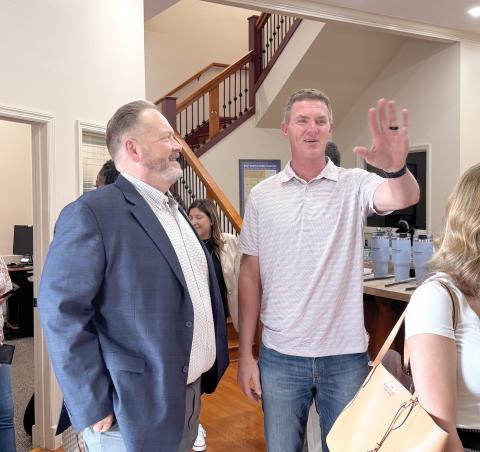 Todd Wilson (left), the publisher of the Lake City Reporter and Live Oak Reporter, speaks with Suwannee County Parks and Recreation Director Alden Rosner during the Reporter’s mix and mingle at its Live Oak office last month. (JAMIE WACHTER/Lake City Reporter)