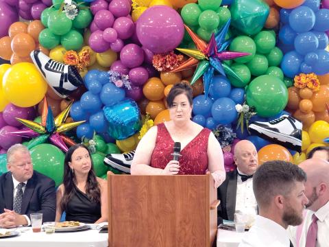 Catholic Charities Regional Director Shannon Moser speaks during Saturday’s Laced Up for Love Sneaker Ball at the Nutrien Conference Center in White Springs. (TONY BRITT/Lake City Reporter)