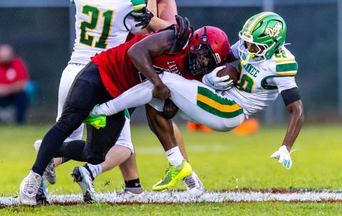 Lafayette defensive lineman Zamarion Hawkins tackles Suwannee running back Lou Jack Smith on Friday. (JACK HOWDESHELL/Lake City Reporter)