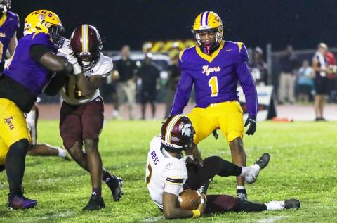 Columbia linebacker Kameron Mills stares down Coffee quarterback Trey Ross after tackling him on Friday. (BRENT KUYKENDALL/Lake City Reporter)