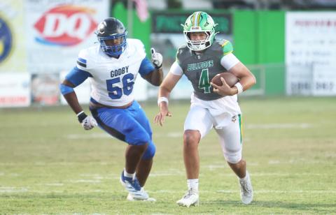 Suwannee quarterback Thomas Sikes scrambles away from pressure against Godby last Friday. (PAUL BUCHANAN/Lake City Reporter)