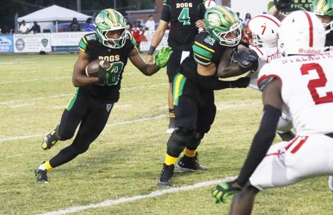 Suwannee running back Lou Jack Smith eyes a hole behind a block from guard Brody Bean against Hamilton County last Friday. (JAMIE WACHTER/Lake City Reporter)