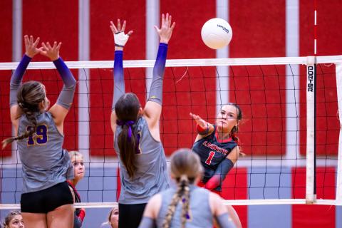 Lafayette hitter Brooke Lamb fires a shot as Columbia hitters Chloe Nickelson (19) and Ava Christie (17) on Monday. (JACK HOWDESHELL/Lake City Reporter)