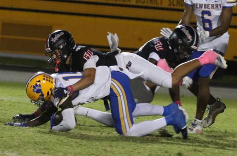 Fort White defensive back Ja’vion Bailem makes a tackle against Newberry on Oct. 17. (MORGAN MCMULLEN/Lake City Reporter)