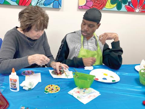 Gateway Art Gallery artist Jeanne Van Arsdall discusses design with CARC painter Tony Lovett. (COURTESY)