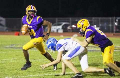 Columbia quarterback Xavier Collins scrambles away from pressure during Friday’s win over Clay. (BRENT KUYKENDALL/Lake City Reporter)