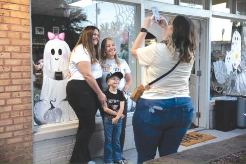 Residents pose in front of the MUSE Candle Studio storefront ahead of Friday’s Ghouls Night Out event in downtown Lake City. (COURTESY)