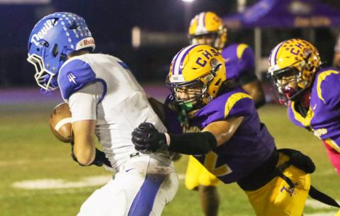 Columbia safety Julian De La Cruz dives to tackle Clay quarterback Landon Martin on Friday. (BRENT KUYKENDALL/Lake City Reporter)