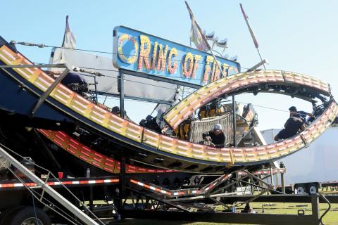 Workers get set on constructing the Ring of Fire, one of the many attractions coming this weekend as the 71st annual Florida Gateway Fair opens at the Florida Gateway Fairgrounds on Friday. (TONY BRITT/Lake City Reporter)