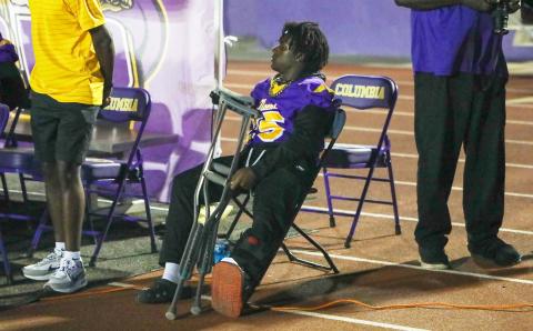 Columbia running back Jerome Horne sits on the sideline Friday night with crutches after fracturing his ankle in practice Wednesday. (BRENT KUYKENDALL/Lake City Reporter)