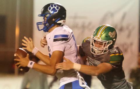Suwannee defensive end Kyler Watson pressures Godby quarterback Landon Dougherty on Sept. 12. (PAUL BUCHANAN/Lake City Reporter)
