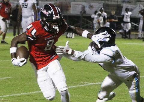 Fort White receiver Jayden Jackson stiff-arms a Zarephath Academy defender Friday night. (MORGAN MCMULLEN/Lake City Reporter)