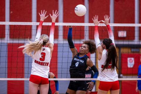 Branford hitter Adriauna Combs delivers a shot past Lafayette's Copelyn Johnson and Maci Wimberley (4) on Oct. 9. (JACK HOWDESHELL/Lake City Reporter).