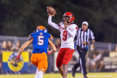 Lafayette quarterback Tywan Williamson releases a pass as Branford’s Devin Waller closes in Friday. (JACK HOWDESHELL/Lake City Reporter)
