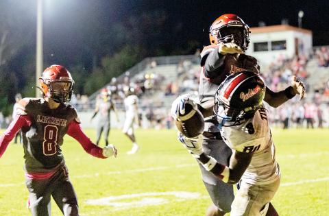 Fort White receiver Jayden Jackson hauls in a touchdown catch behind Lafayette defenders Parker Hill (8) and Tywan Williamson on Friday night. (ACK HOWDESHELL/Lake City Reporter)