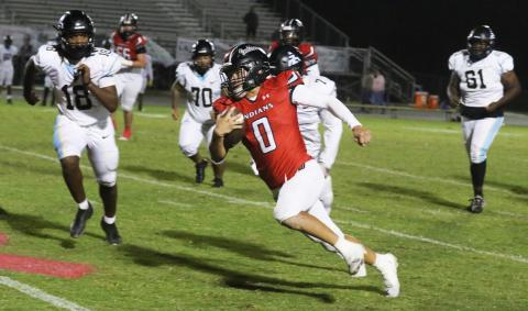 Fort White running back Ezekiel Powell sprints around the Zarephath Academy defense during last Friday’s 49-6 win. (MORGAN MCMULLEN/Lake City Reporter)