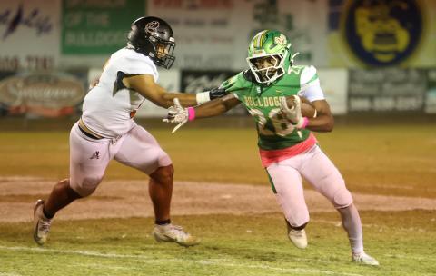Suwannee running back Lou Jack Smith tries to escape a tackle from an Atlantic Coast defender last Friday. (PAUL BUCHANAN/Lake City Reporter)