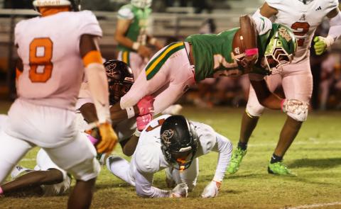 Suwannee running back Lou Jack Smith gets upended by an Atlantic Coast defender on Friday. (PAUL BUCHANAN/Lake City Reporter)