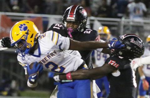 Newberry running back Kaleb Woods stiff-arms Fort White defensive back Jayden Jackson during Friday’s 25-7 loss. (MORGAN MCMULLEN/Lake City Reporter)