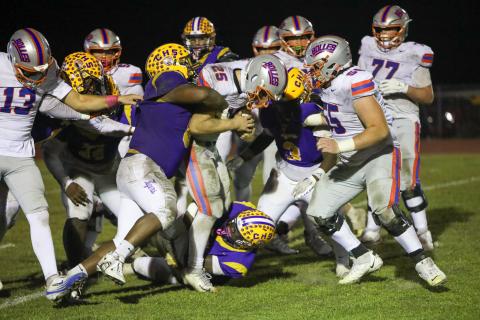 Bolles running back Xander Edwards carries Columbia defenders for extra yardage during his team’s 31-0 win on Friday. (BRENT KUYKENDALL/Lake City Reporter)
