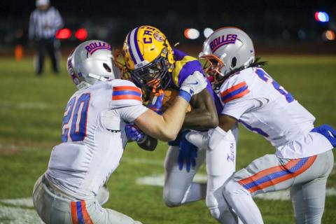 Columbia receiver Kyren Caldwell gets wrapped up by a pair of Bolles defenders following a catch on Friday. (BRENT KUYKENDALL/Lake City Reporter)