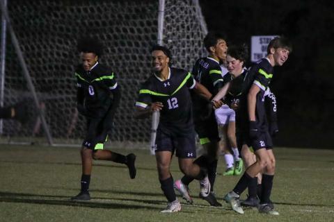 Columbia's Josiah Hopkins (12) celebrates with teammates after scoring a goal against Keystone Heights on Monday. (BRENT KUYKENDALL/Lake City Reporter)