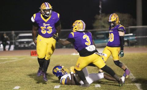 Columbia defensive tackle Jaden McCray (53) celebrates with defensive end Terry Henry (3) and linebacker Bryson Grinstead (20) after stuffing Rickards running back Karlise Price for a loss during Friday’s Region 1-4A quarterfinal. (BRENT KUYKENDALL/Lake City Reporter)