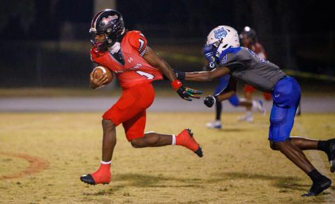 Fort White running back John'l Lawson breaks a tackle on his way to a touchdown against Wildwood during the FIT quarterfinals on Thursday. (BRENT KUYKENDALL/Lake City Reporter)