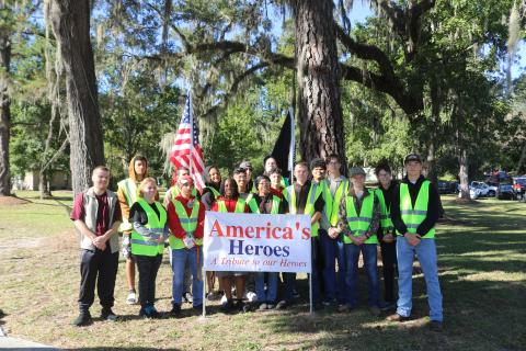 Columbia High School JROTC cadets, volunteers and chaperones pose for a picture on Saturday after helping Columbia County Republican Executive Committee members erects flags and crosses for their America’s Heroes program. (TONY BRITT/Lake City Reporter)