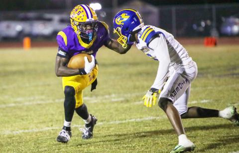 Columbia receiver Kyren Caldwell fights off a Rickards defender during last Friday’s Region 1-4A quarterfinal. (BRENT KUYKENDALL/Lake City Reporter)