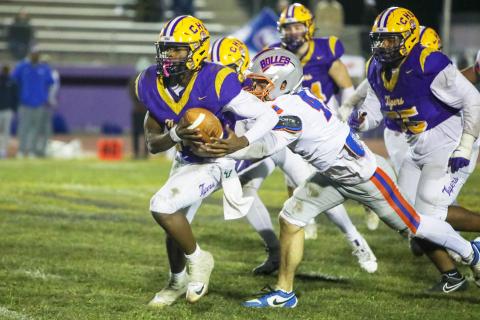 Columbia quarterback Xavier Collins tries to escape pressure from the Bolles defense on Oct. 31. (BRENT KUYKENDALL/Lake City Reporter)
