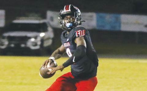 Fort White quarterback Jayden Jackson rolls out to pass during Friday’s win over Baker County. (MORGAN MCMULLEN/Lake City Reporter)
