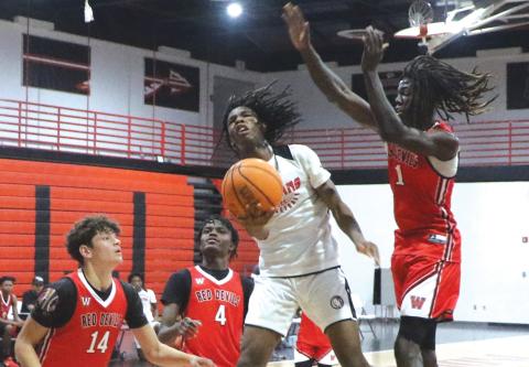 Fort White guard Tylan James goes airborne for a layup attempt against Williston during the Indians’ summer league opener in June. (FILE)
