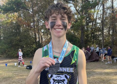 Suwannee runner Logan Haley shows off his state medal after placing 11th at the Class 2A state meet on Saturday. (COURTESY)