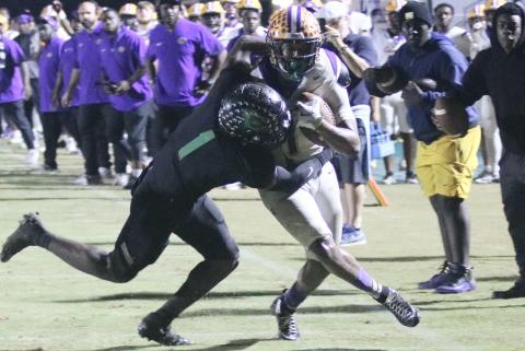 Columbia running back Kameron Mills is stopped by Choctaw safety Alante Reese two yards short of the first down on 4th-and-4 in the final minute of Friday's Region 1-4A semifinal. (JORDAN KROEGER/Lake City Reporter)