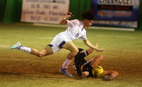 Columbia's Peyton Palmer battles for possession against Suwannee on Wednesday. (PAUL BUCHANAN/Lake City Reporter)